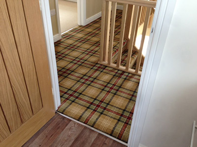 Beige tartan carpet on landing