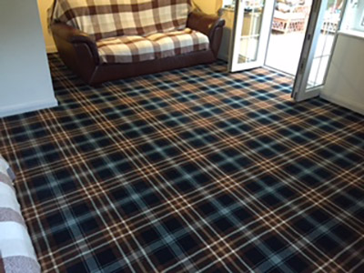 Dark tartan carpet in lounge